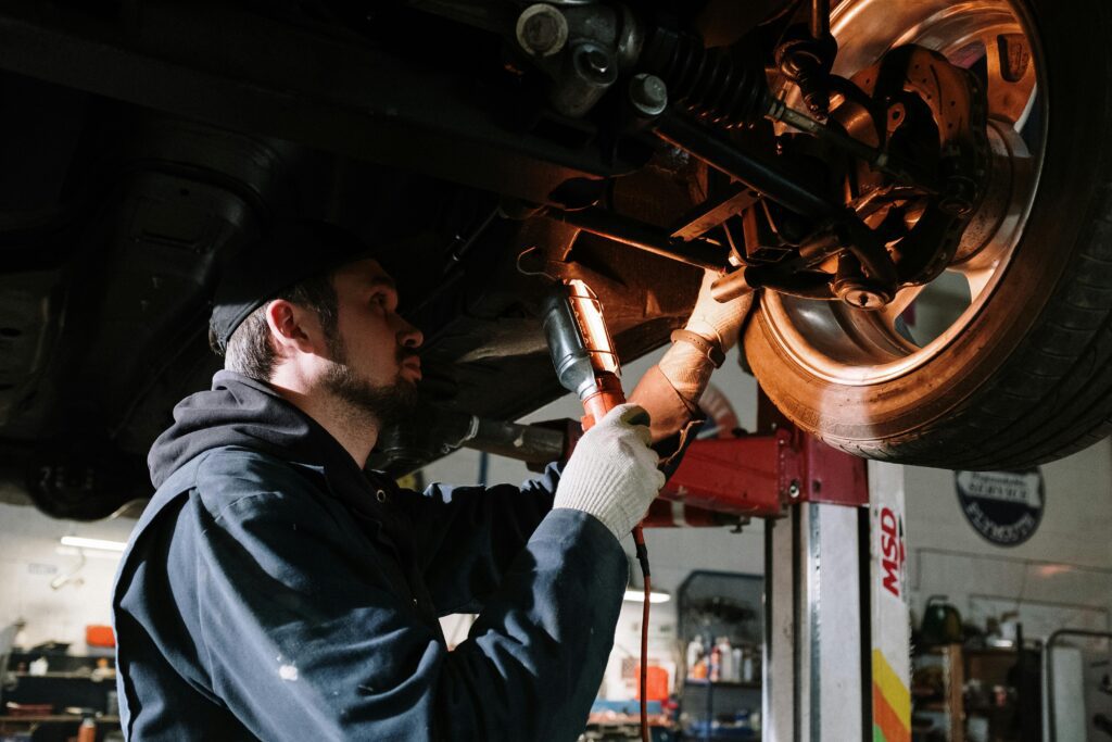 Auto repair technician inspecting wheel