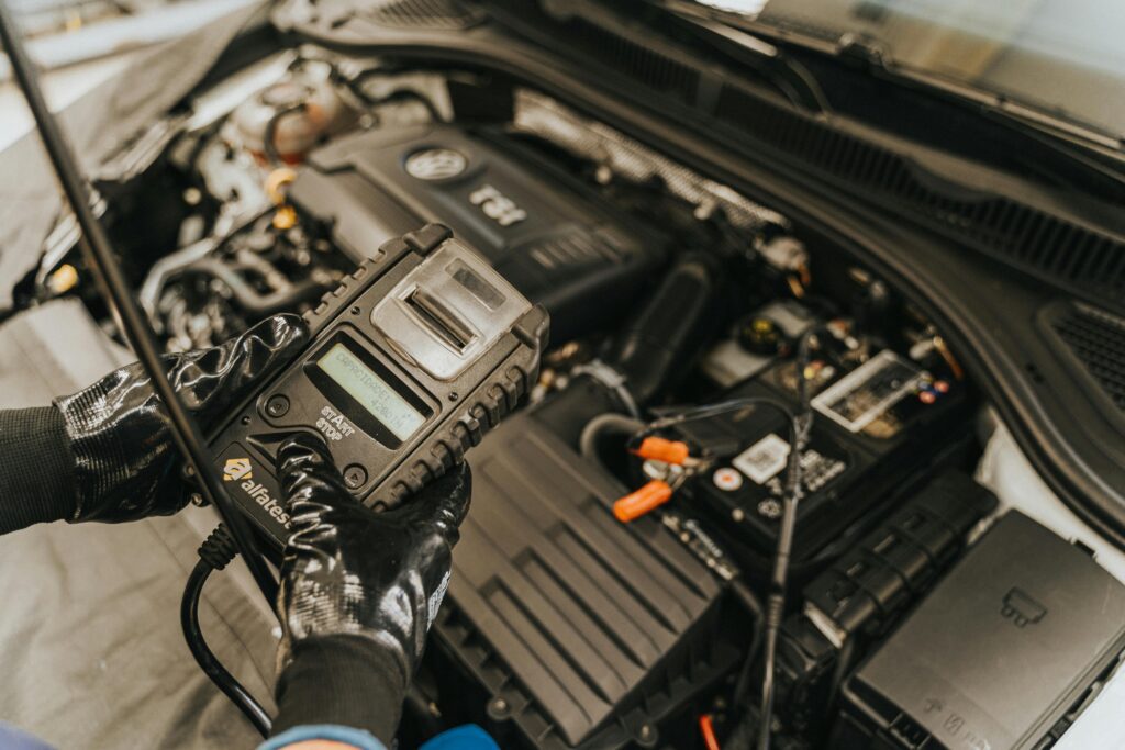 Mechanic using specialized digital tool on engine